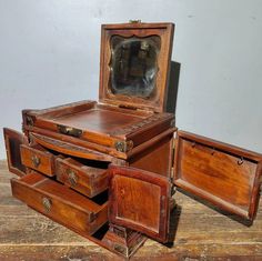 an old wooden desk with drawers and mirror