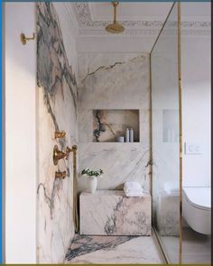 a bathroom with marble walls and flooring