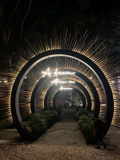 a person sitting in the middle of a tunnel with lights on it's sides