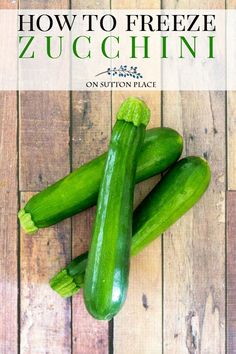 three green cucumbers sitting on top of a wooden table