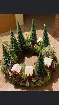 a wreath made out of fake trees and houses