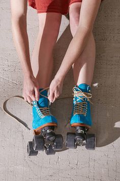 a person tying their shoes on roller skates