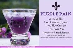 a purple drink in a glass sitting on top of a table