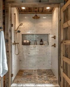 a walk in shower sitting inside of a bathroom next to a wooden door and window