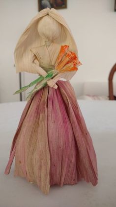 a bag filled with flowers sitting on top of a white tablecloth covered table cloth