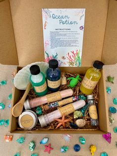 an open box with various items in it on a table next to confetti