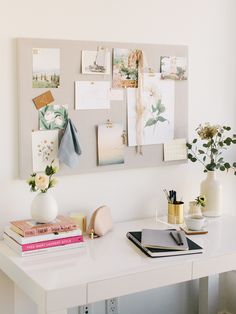 a white desk topped with lots of pictures and papers