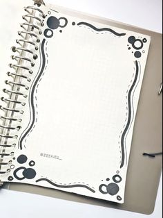 an open spiral notebook sitting on top of a table