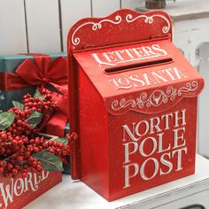 two red mail boxes sitting next to each other on top of a white countertop