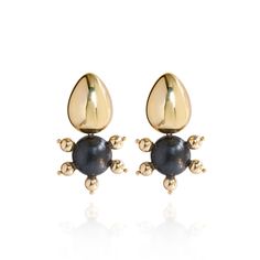 The Tulia Earrings in Black Coral are a chic addition to any wardrobe that favors clean lines and metallic accents. Featuring a hand-painted wooden center, gold hematite beads, and an 18K gold-plated teardrop post, these earrings offer versatile style with a touch of sophistication. Available in modern neutrals, the Tulia Earrings effortlessly elevate any outfit, from breezy linen sundresses to sharp tailored trousers.  Materials: Non-toxic Paints, Wood Base, 18K Gold Plated Brass Beads, 18K Gol Gold Shell-shaped Metal Earrings, Gold Shell-shaped Earrings, Elegant Tortoiseshell Drop Earrings, Gold Shell-shaped Brass Earrings, Gold Plated Shell-shaped Earrings, Black Coral, Brass Beads, Forever Jewelry, Hematite Beads