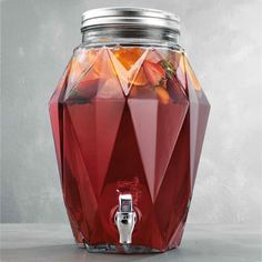 a glass jar filled with liquid and fruit