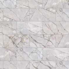 a white marble tile wall that looks like it has been made out of different types of tiles