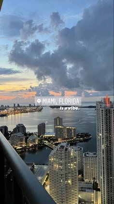 the city skyline is lit up at night with clouds in the sky and buildings on the other side