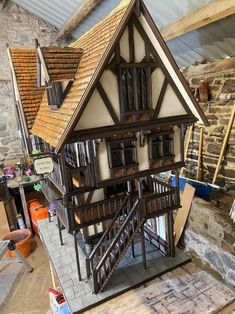 a doll house is shown in the process of being built with wood trimmings