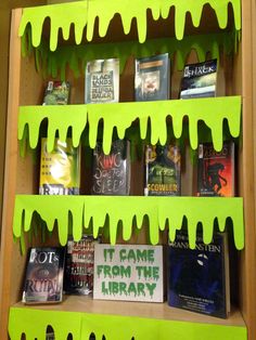 a book shelf filled with books covered in green paint