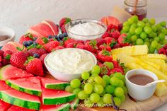 a platter filled with fruit and dips