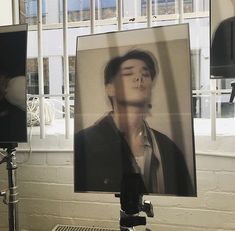 a photograph of a man is being displayed on a tripod