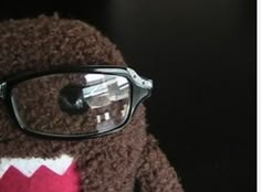 a teddy bear with glasses on it's face