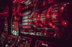 several slot machines with red lights on them