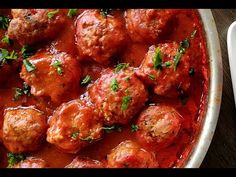 meatballs covered in marinara sauce and garnished with parsley