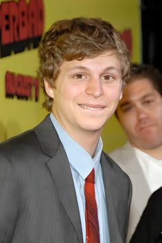 a young man wearing a suit and tie