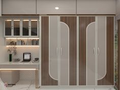 a bedroom with white and brown closets next to a desk in front of a window