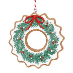 a christmas wreath ornament hanging from a red and green ribbon on a white background