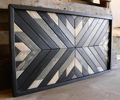 a wood paneled wall with black and white designs on it