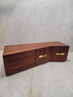 a large wooden cabinet with two brass handles