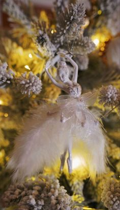 an ornament is hanging on the tree in front of pine cones and other decorations