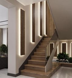 the stairs are lit up with leds in this modern living room, along with potted plants