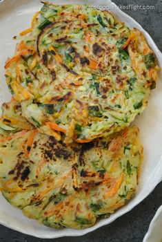 three vegetable fritters on a white plate