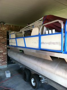 a boat is sitting on the back of a truck in a garage with no one around it