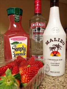 the ingredients to make strawberry margarita are neatly arranged on the counter, including strawberries