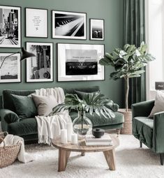 a living room with green walls and pictures on the wall above the couch, coffee table