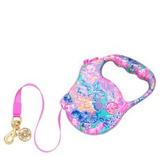 a pink leash attached to a blue and white purse with an animal design on it