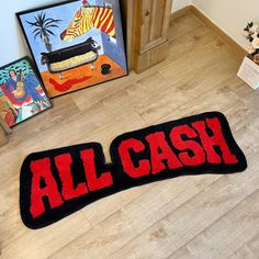 an all cash rug is on the floor in front of some other paintings and toys