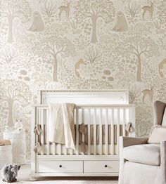 a baby's room with an animal themed wallpaper