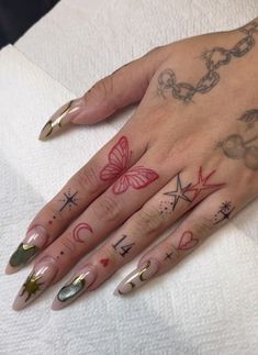 a woman's hand with tattoos on it