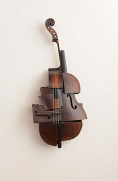 a violin hanging from the side of a wall