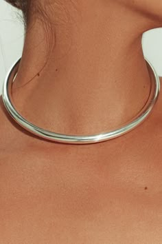 Made in Brazil, this tube choker’s sleek design is sculpted from sterling silver – simple enough for everyday and special enough for nights out and occasion. The perfect weight for solo wear or stacking, layer as desired for a modular effect. Jewelry Collection Handcrafted in Brazil Sterling Silver over Brass Thickness: 8.3mm Inner Diameter: 5" Opening: 3.25" Weight: 0.90 oz Waterproof Hypoallergenic Silver Tube Necklace, Silver Necklace Choker, Unique Silver Necklaces, Silver Necklace Stack, Silver Necklaces Layered, Thick Silver Necklace, Chain Necklace Outfit, Day Collar, Necklace Outfit