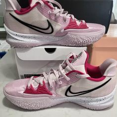 a pair of pink and white nike shoes