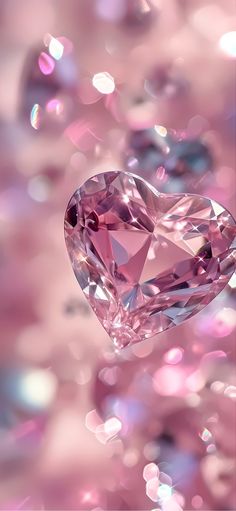 a pink heart shaped diamond floating in the air