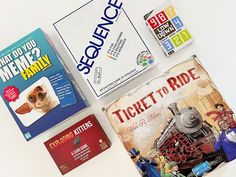 some books and games are laying out on the table with each one's name