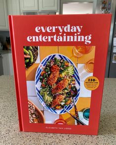 the cookbook is sitting on top of the counter