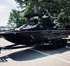 a black boat parked in a parking lot