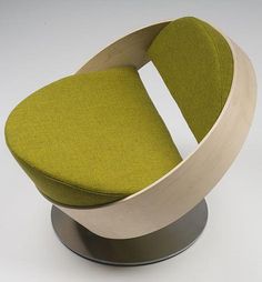 a green chair sitting on top of a metal base