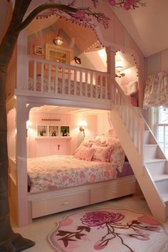 a bunk bed with stairs leading up to the top floor and pink bedspread