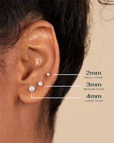 an ear with three small diamond studs attached to the back of it, and measurements