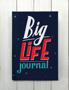 a sign that says big life journal on the side of a wooden fence with stars